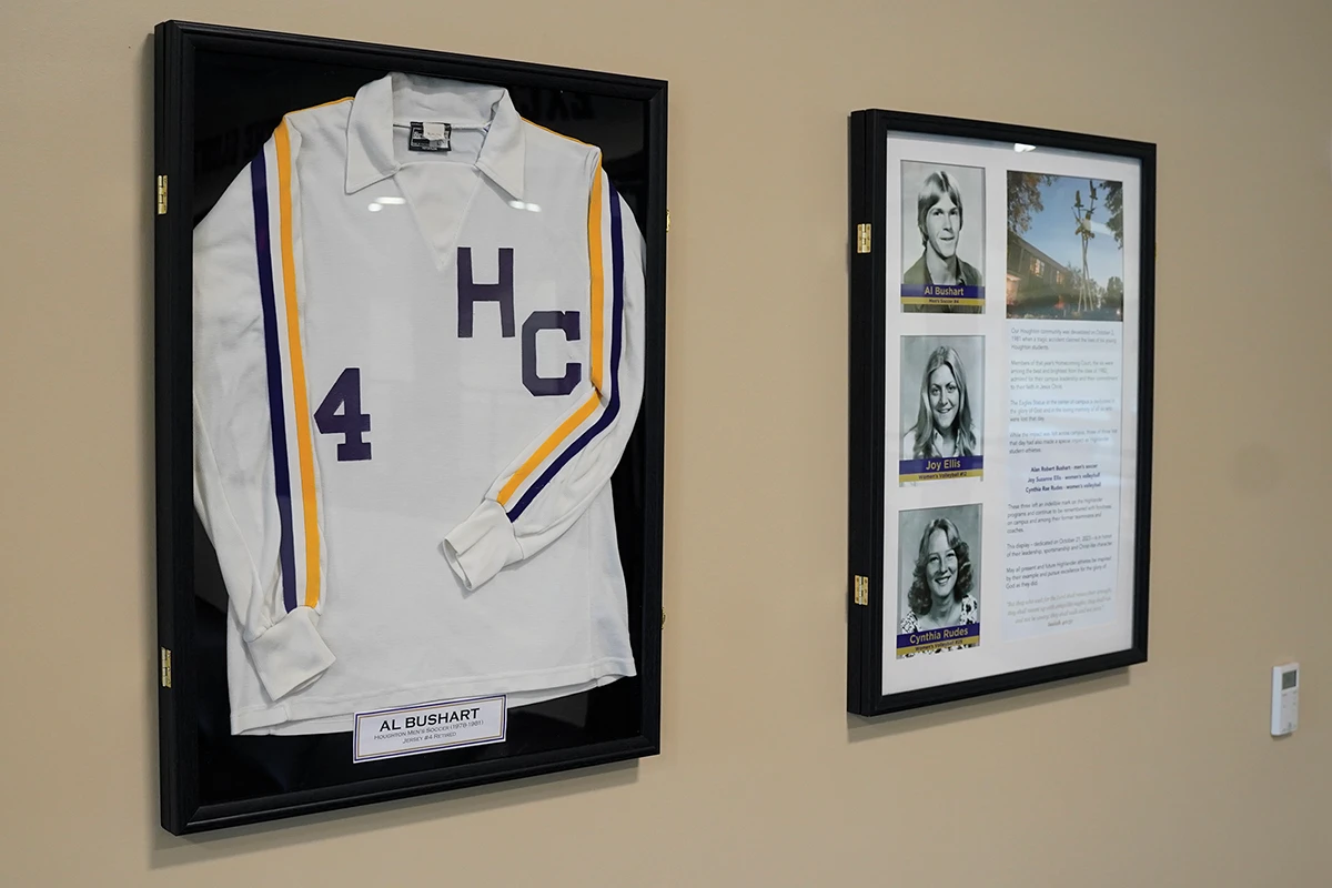 Houghton framed sports jersey and framed photograph on wall.