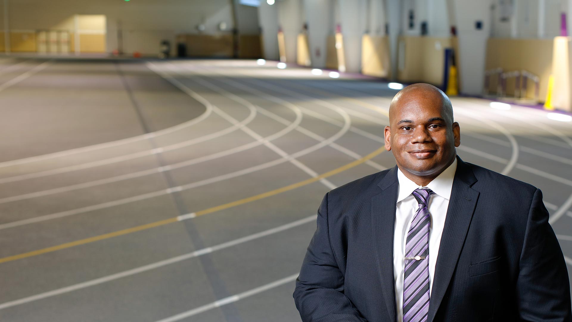 Houghton President, Wayne D. Lewis, Jr., standing on the track in the KPAC