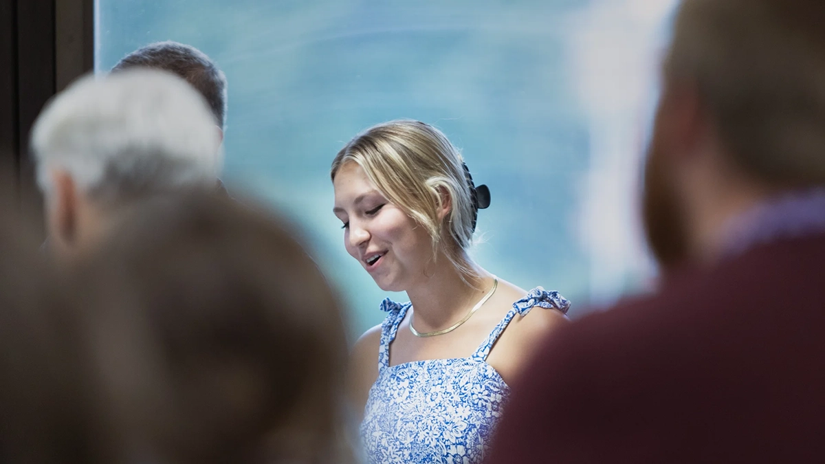 Attendee singing during worship time at the Christian School Summer Symposium.