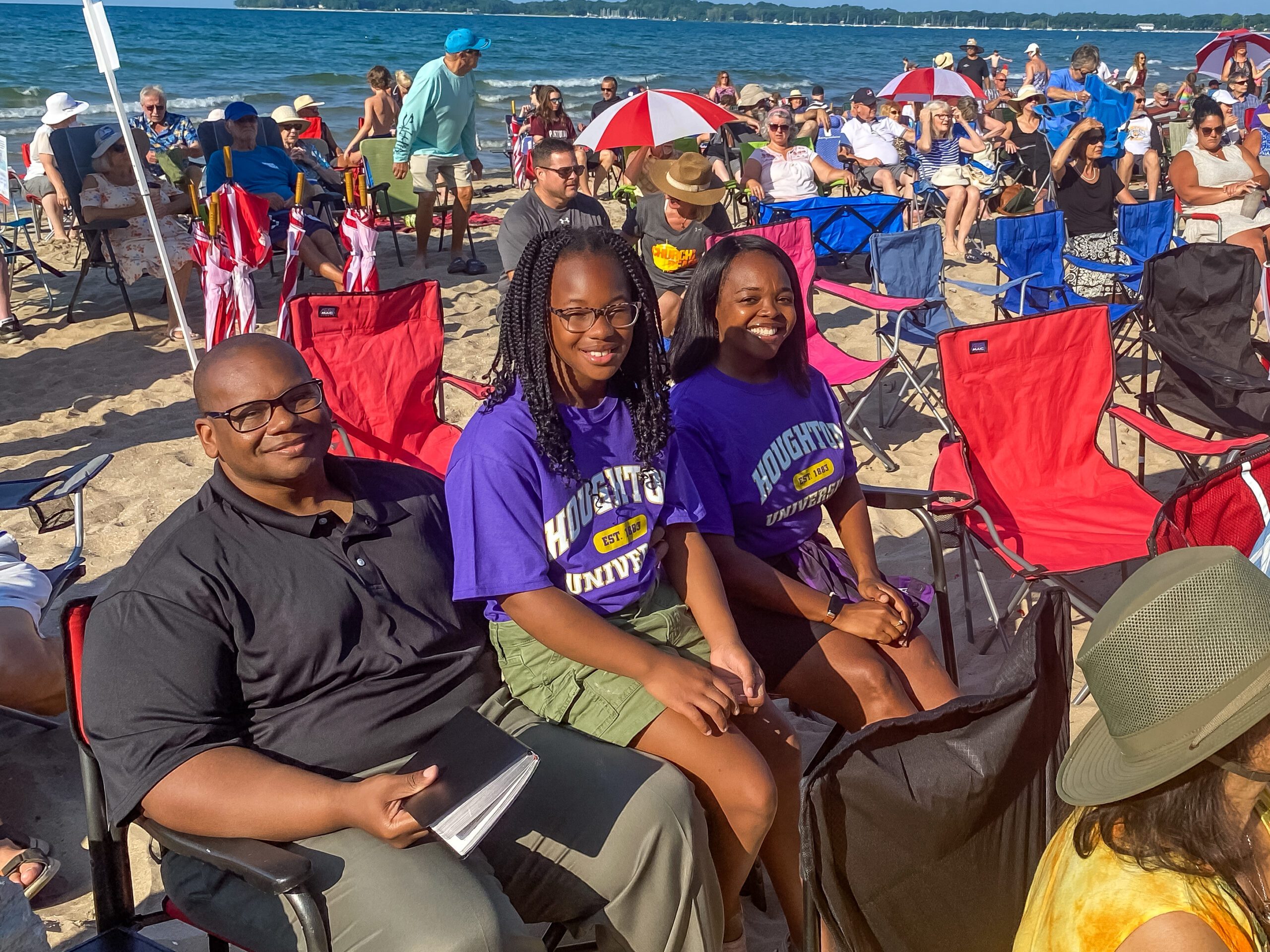 Lewis family smiling as they enjoy church on the beach