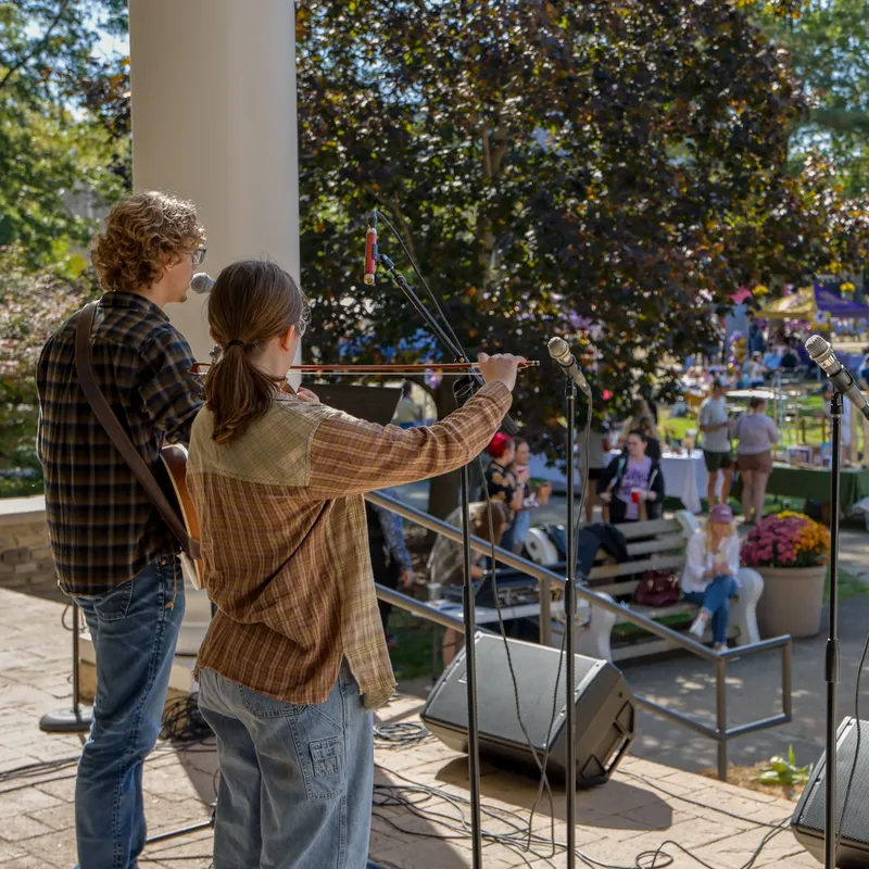 students playing music on chapel steps