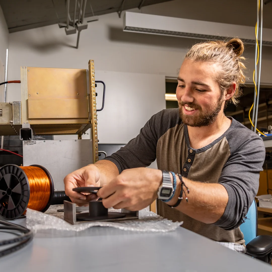 Houghton Applied Physics student working with equipment in lab.