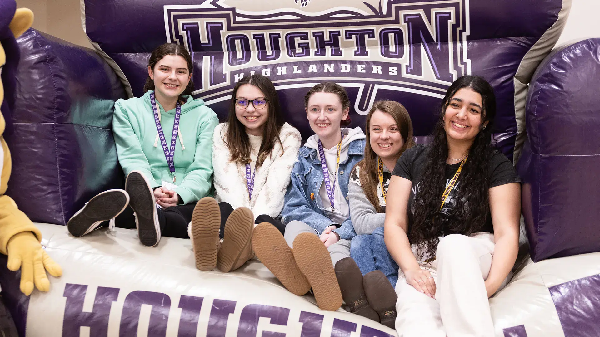 Five future Houghton students sitting on large inflatable chair at Accepted Students Day.