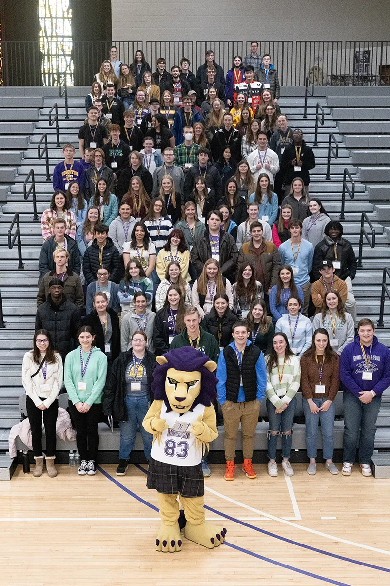 Houghton accepted students standing on bleachers with Luckey.