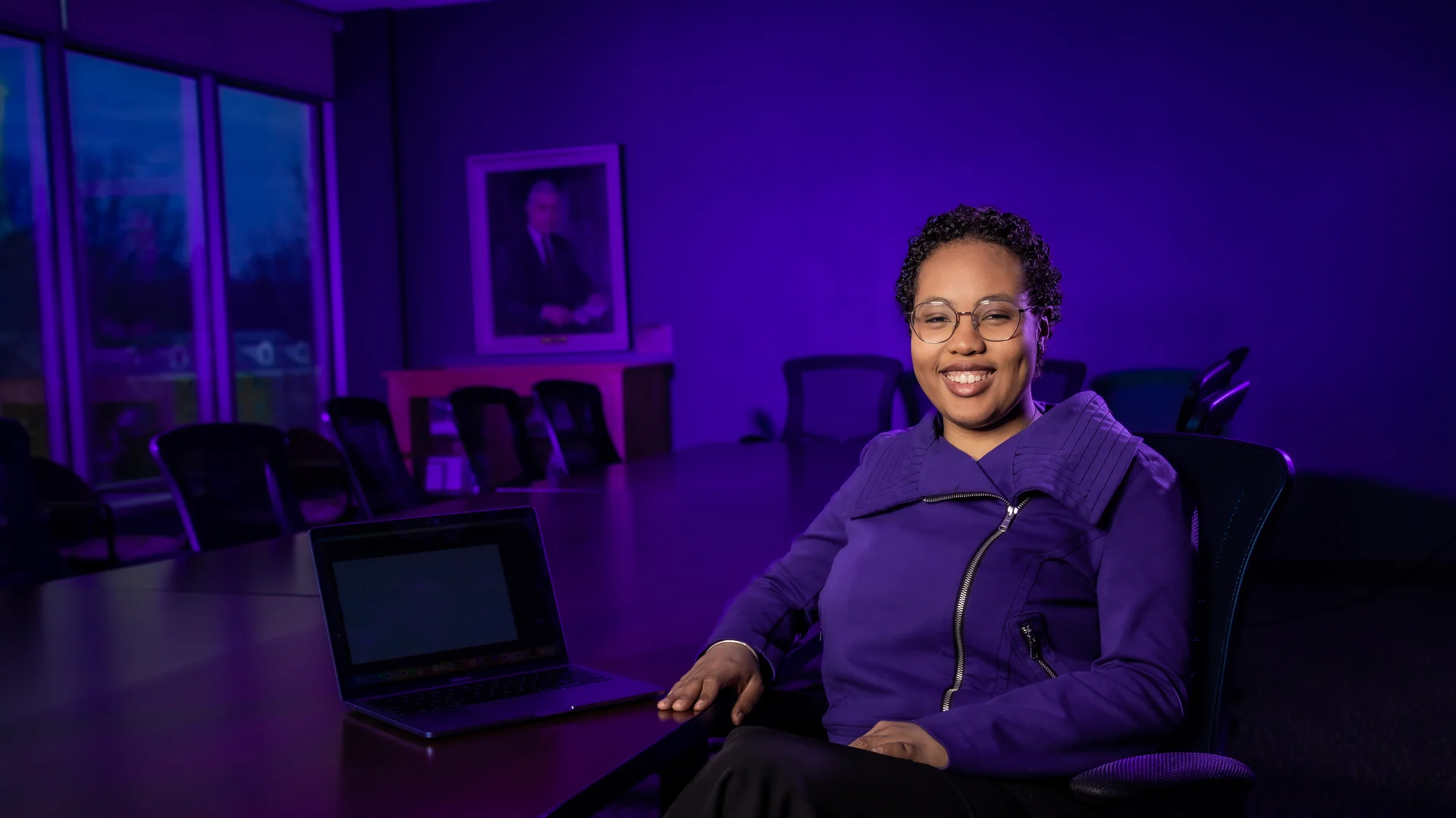 Houghton business student Johanna Borges Edward sitting at large conference table.