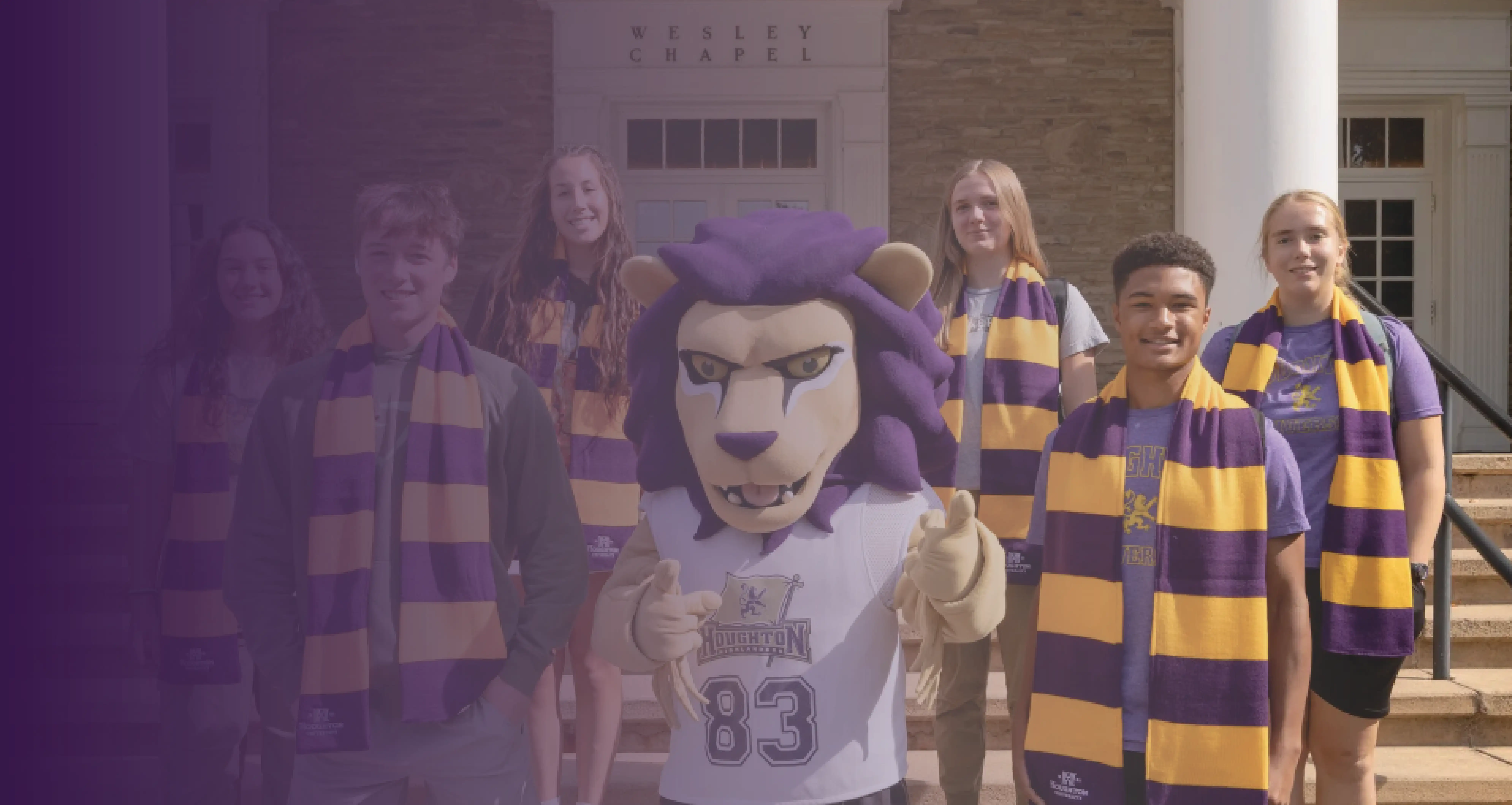 Students on chapel stairs smiling with luckey the lion and houghton scarves.