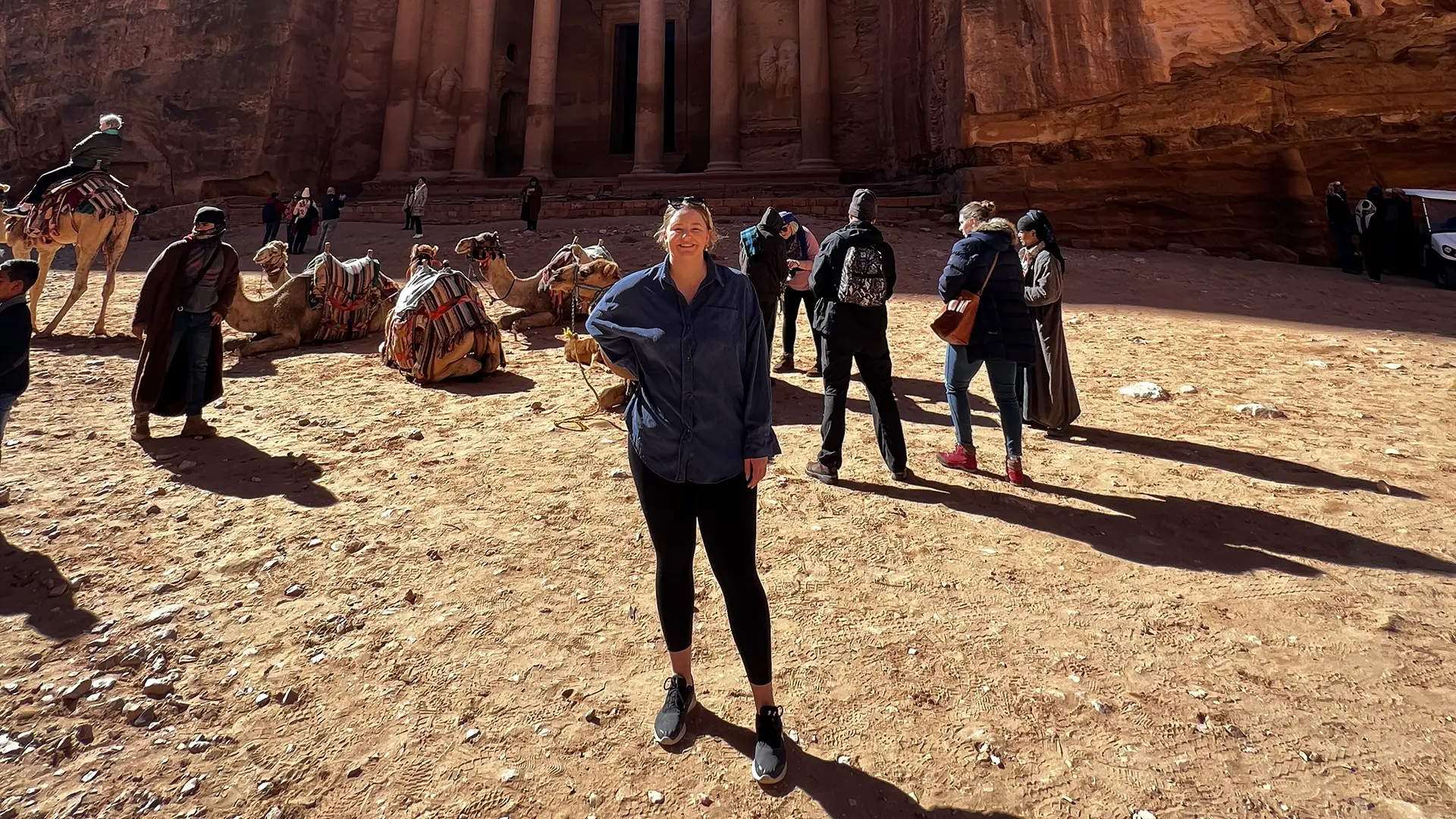 Alumna Kaylee Fisher standing in front of historic monument built into hillside.