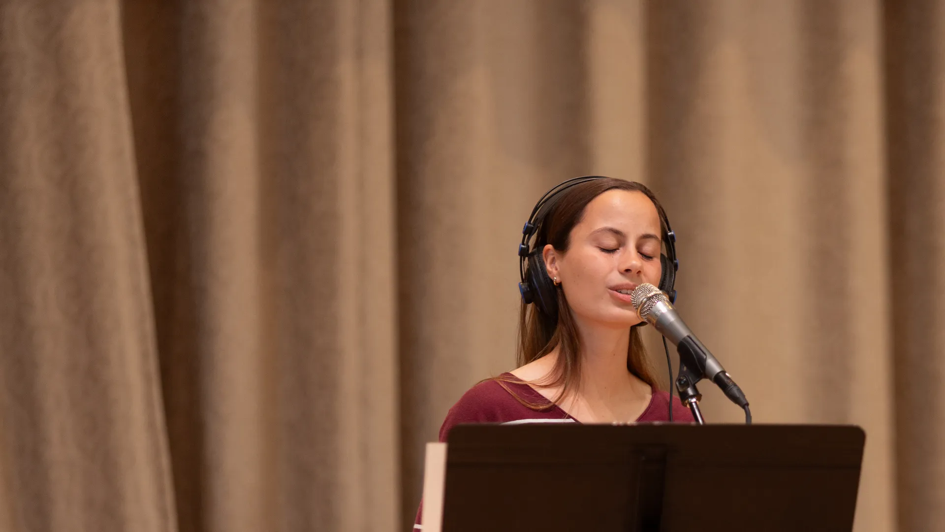 Houghton student singing on stage during Chapel.