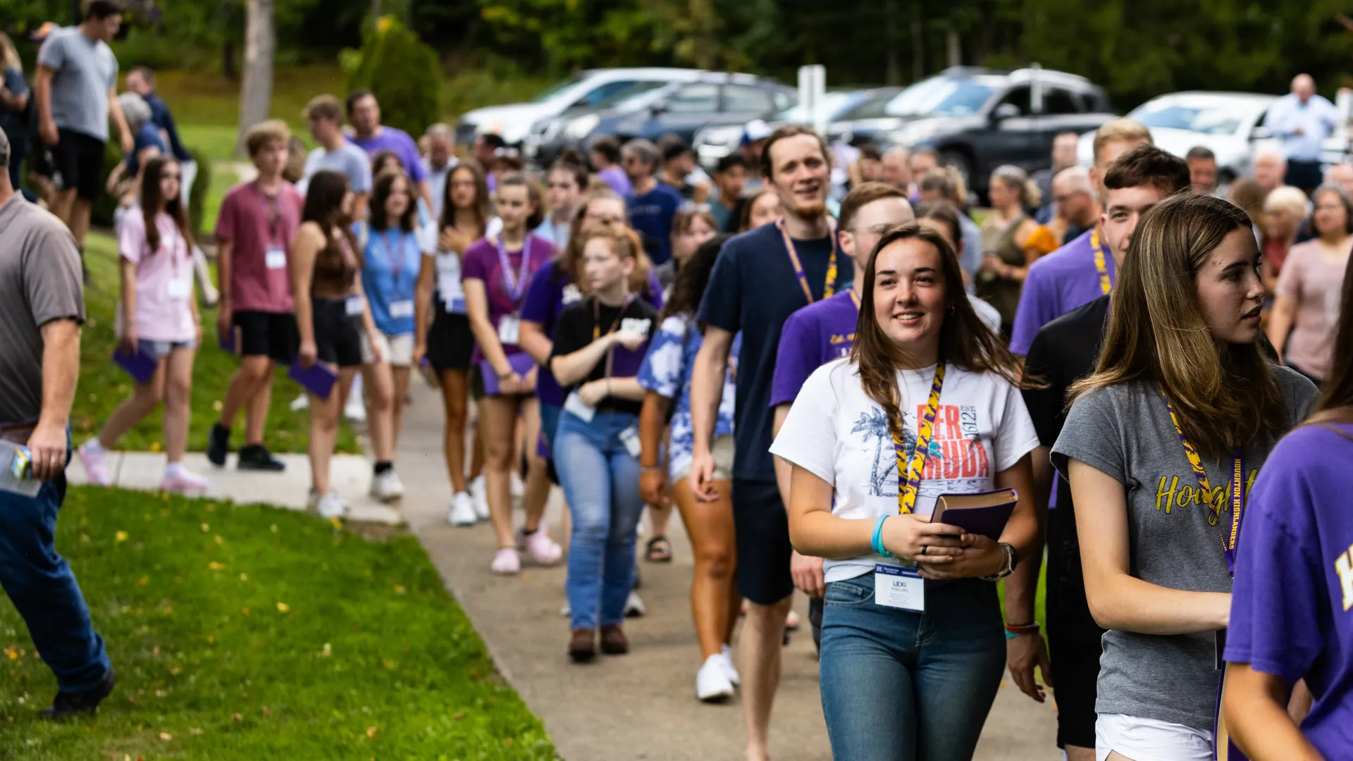 First year Houghton students walking out of chapel with their new purple bibles.