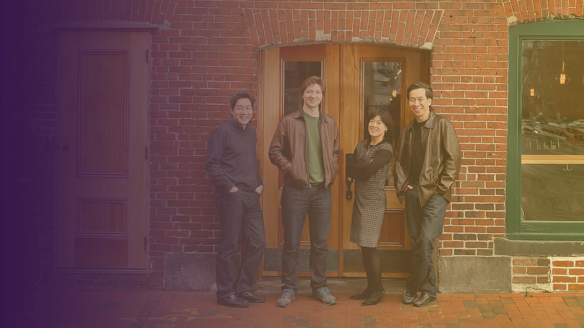 The Ying Quartet standing in front of brick building.