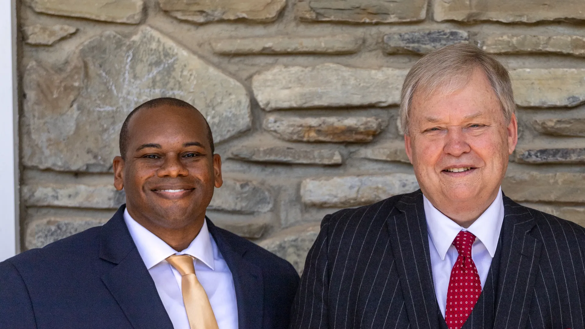 Alumnus David Causer standing with Houghton University president Dr. Wayne Lewis.