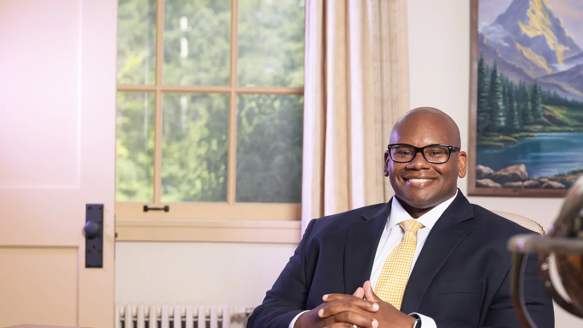 President Lewis of Houghton University sitting at desk.