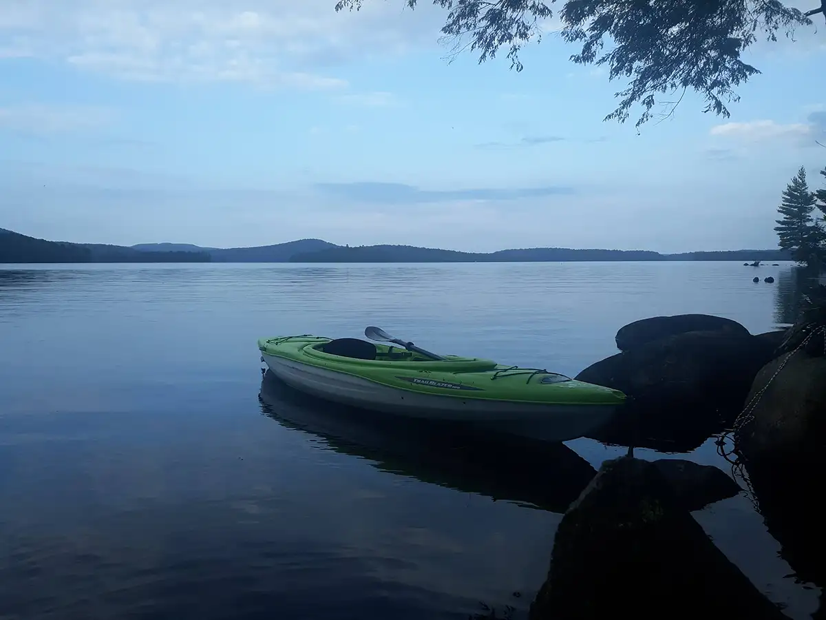 Empty kayak on still water of lake.