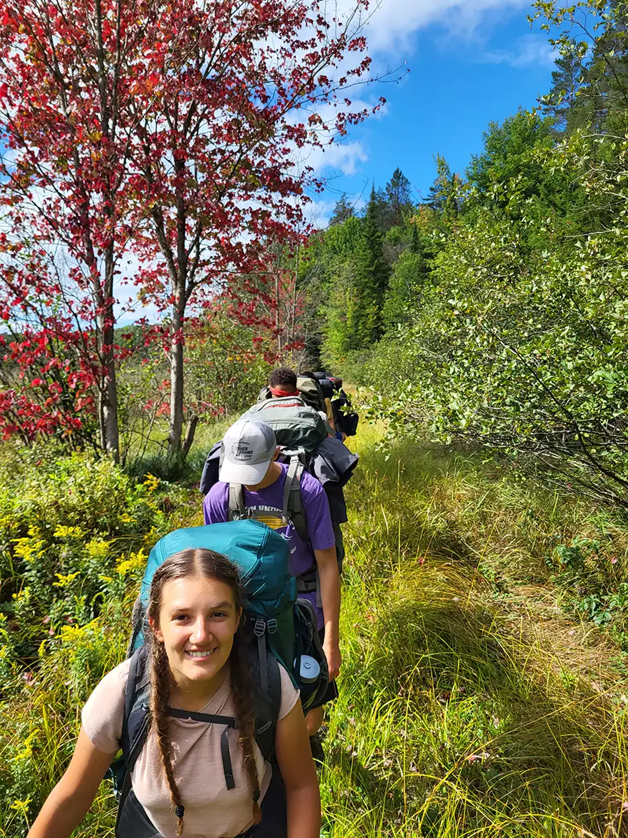 Houghton Highlander Wilderness Adventure students hiking on path.