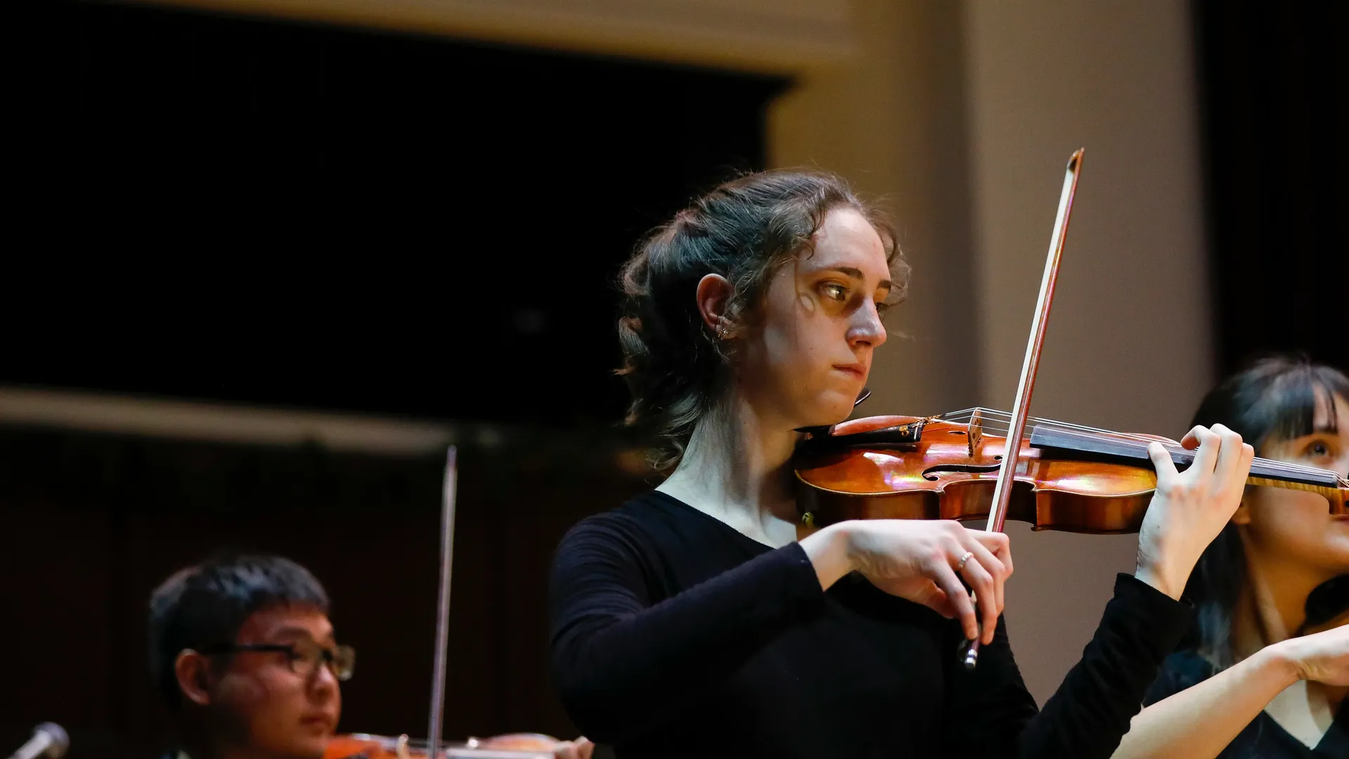 Houghton University music major student playing violin at Christmas PRISM concert.