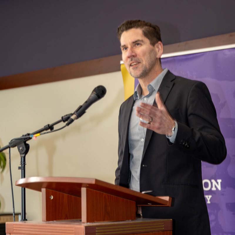Provost David Davies speaking to students from a podium