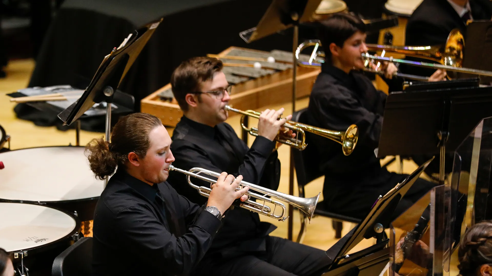 Houghton music students playing brass instruments during performance.