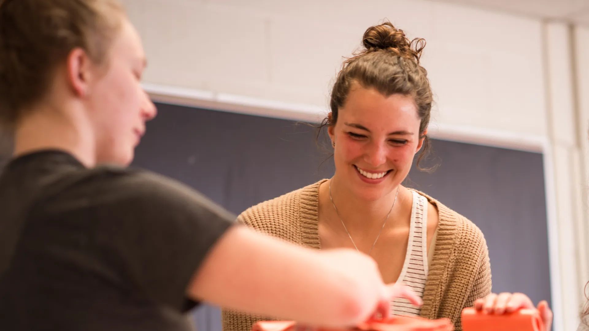 Girl smiling and working in a therapy lab.