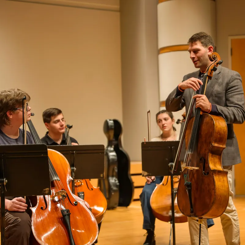 Cellist teaching students