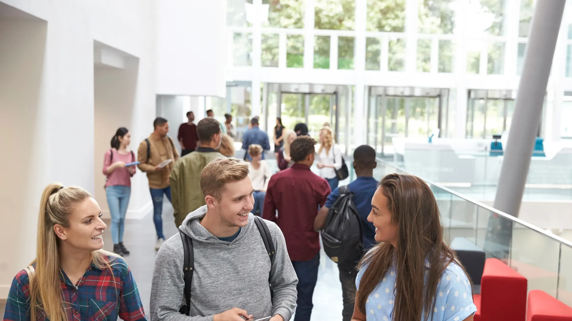 Three students talking in the hallway