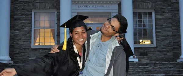 Photo of two siblings outside of the building at graduation
