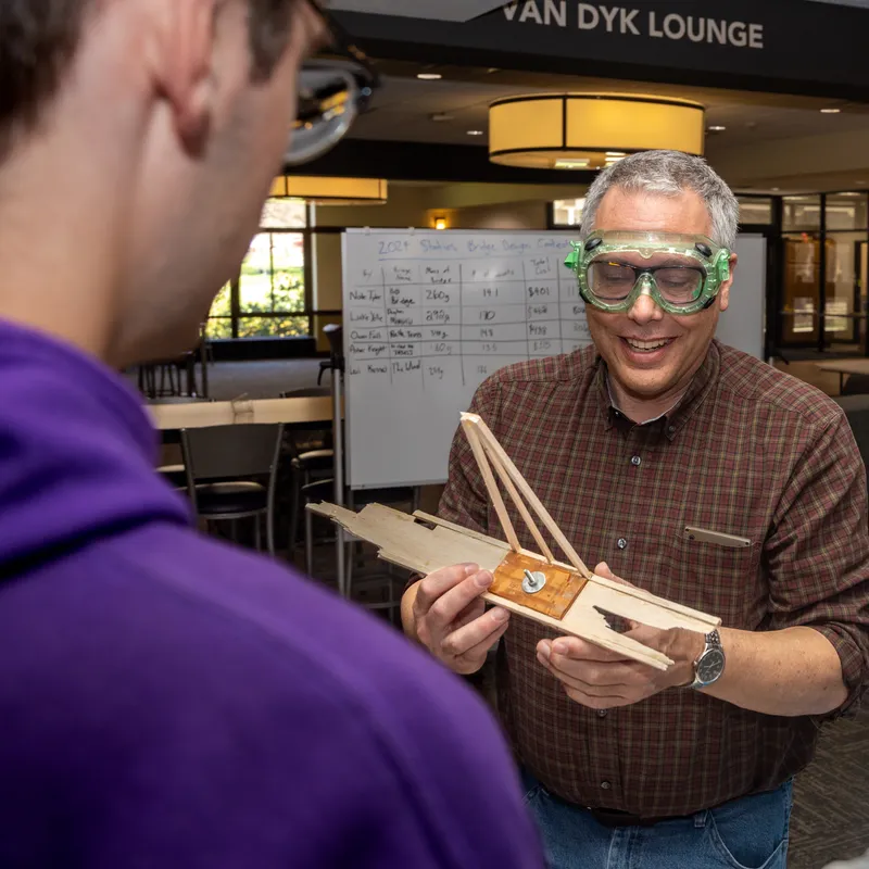 Professor working with physics student